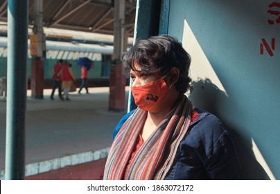 Howrah Station platform, Kolkata, 11-22-2020: A fashionable Indian woman wearing ethnic kurti, standing near door, inside a train compartment. She is wearing cloth face mask for Covid-19 protection.