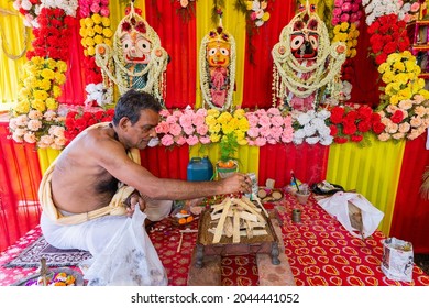 Howrah, West Bengal, India - 29th June 2020 : Hindu priest arranging yajna to worship idol of God Jagannath, Balaram and Suvodra inside pandal , in front of sacred fire with mantras.