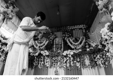 Howrah, West Bengal, India - 7th July 2019 : Hindu priest worshipping idol of God Jagannath, Balaram and Suvodra. Ratha jatra festival is famous festival in India. Black and white.