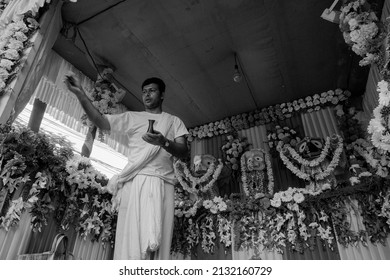 Howrah, West Bengal, India - 7th July 2019 : Hindu priest worshipping idol of God Jagannath, Balaram and Suvodra. Ratha jatra festival is famous Hindu festival in India. Black and white.