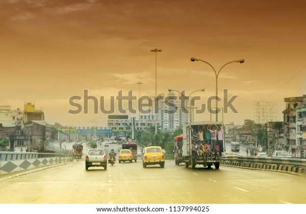 HOWRAH,\
WEST BENGAL , INDIA - AUGUST 7TH 2016 : Vidyasagar Setu (Bridge)\
over river Ganges, known as 2nd Hooghly Bridge in Kolkata,West\
Bengal,India. Orange afternoon sky in\
background.