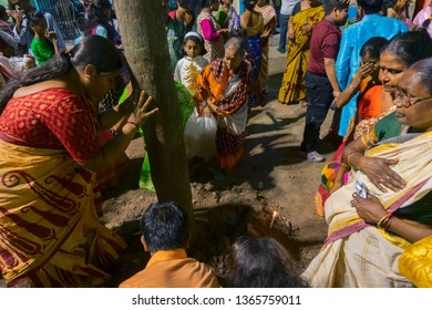 HOWRAH,WEST BENGAL, INDIA - APRIL 15TH, 2018 : Women Praying To Wood - During Gajan And Charak Puja-a Hindu Festival. Lord Shiva, Neel And Dharmathakur Are Worshipped. Ends Before Bengali New Year.