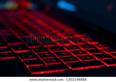 HP omen keyboard with red back lit keys with a shallow depth of field
