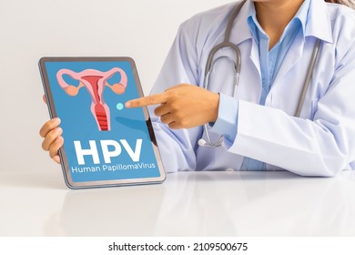 HPV (Human Papillomavirus) Female Doctor Explaining Knowledge And Pointed Out Women Health Problems On Tablet Screen, Viruses Some Strains Infect Genitals And Can Cause Cervical Cancer.