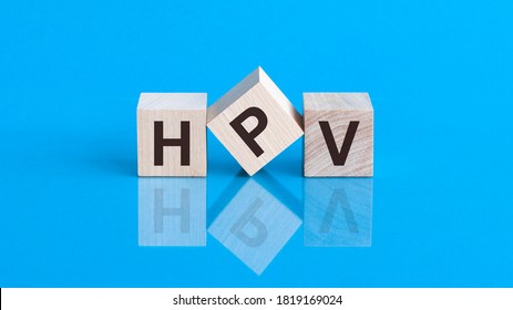 HPV - Human papillomavirus, word written on blocks. Humani Papilloma Virus inscription on blue background. Medical viruses concept.