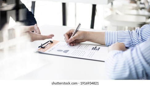 The HR department is reviewing the resumes of job applicants, resumes are important documents for job application. It should contain resume, training history, education, talent, work skills, etc. - Shutterstock ID 1916934821