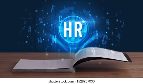 HR inscription coming out from an open book, digital technology concept