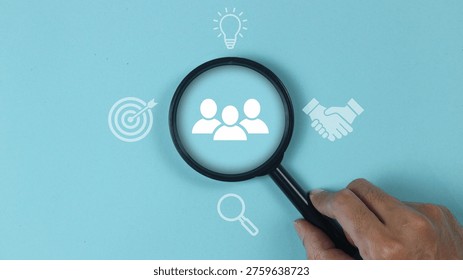 HR management concept involves the strategic administration of human resources within an organization to optimize employee performance and organizational growth. This visual representation highlights the core pillars of the field, focusing on professional recruitment, specialized training, and effective conflict resolution. By utilizing a magnifying glass over a team of professionals, the image emphasizes the meticulous search for talent and the importance of fostering a productive organizational culture. It serves as a visual guide for human resource departments aiming to align individual goals with corporate objectives through systematic talent acquisition and workforce development