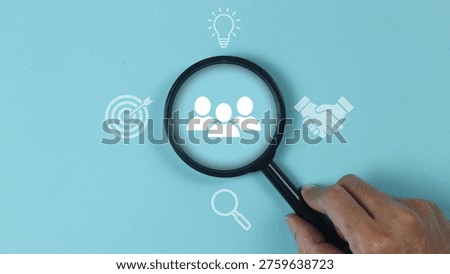 HR management concept involves the strategic administration of human resources within an organization to optimize employee performance and organizational growth. This visual representation highlights the core pillars of the field, focusing on professional recruitment, specialized training, and effective conflict resolution. By utilizing a magnifying glass over a team of professionals, the image emphasizes the meticulous search for talent and the importance of fostering a productive organizational culture. It serves as a visual guide for human resource departments aiming to align individual goals with corporate objectives through systematic talent acquisition and workforce development