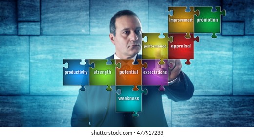 HR Manager With Focused Look Touching A Jigsaw Puzzle Imprinted With Performance Appraisal Terms. Concept For Career Development, Self Assessment, Human Resources Management And Talent Acquisition.