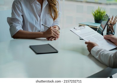 An HR manager interviews one of the candidates who posted Select Focus. A male job seeker holding a resume congratulating a successful successful good interview concept position. - Shutterstock ID 2157232711
