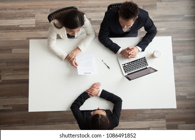 Hr managers interviewing female job applicant, recruiters listen to candidate answering questions at hiring negotiations, recruiting and staffing, making first impression concept, top view from above
