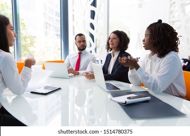 HR managers interviewing job applicant. Business man and women sitting at conference table, using laptops and talking. Negotiation or career concept
