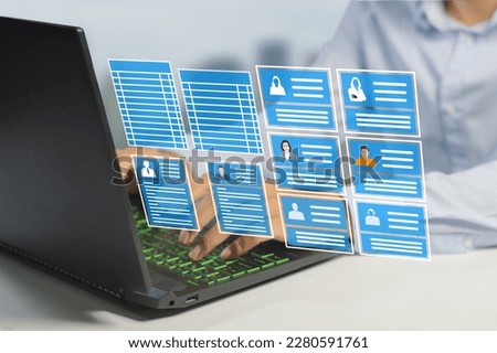 HR officer working on a laptop with employee data to manage payroll , holiday leave and recruit more staff