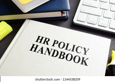 HR Policy Handbook On An Office Desk.