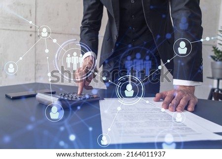 HR specialist researching and analyzing the data of salary on employment market to forecast ongoing expenses of the company using calculator. Hiring new talented officers. Social media hologram icons