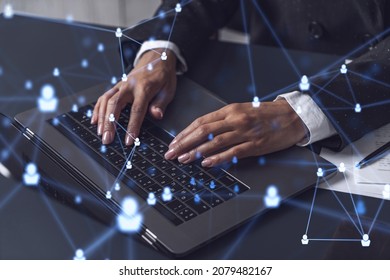 HR woman specialist is typing the keyboard in the internet to find the best candidates to create international network in recruitment process. Formal wear. Social media hologram icons. - Shutterstock ID 2079482167