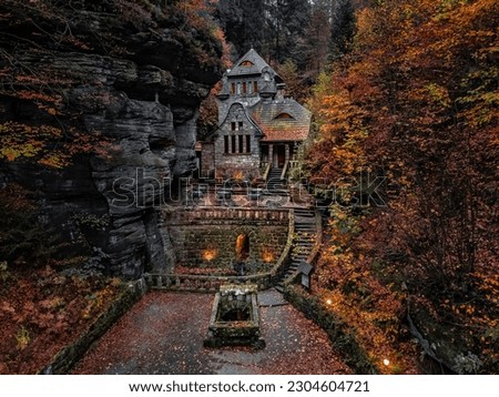 Hrensko, Czech Republic - Aerial view of a lovely stone cottage in the Czech wilderness near Hresko at autumn with beautiful colorful fall foliage