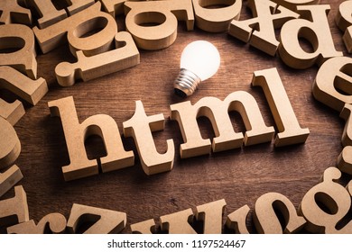 HTML abbreviation (Hypertext Markup Language) in scattered wood letters with glowing white light bulb