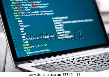 HTML Code on laptop screen. Web Design Concept.