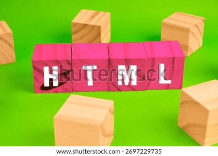 HTML coding concept with blocks forming the acronym beside scattered cubes, representing web development foundations and digital structure.
