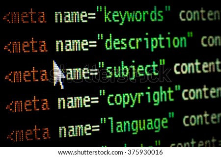 HTML web page computer programming code meta tags in red light and dark green with mouse pointer on black background seo optimization ranking search engines