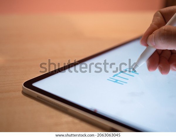 HTTP, HyperText Transfer Protocol\
Hypertext transfer Protocol. The hand makes an inscription on the\
tablet screen using a stylus, close-up small depth of\
field