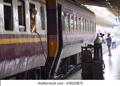  Hua Lamphong (Bangkok Train Station) Train Station, Bangkok, Thailand - June 10, 2017 A Man Doing Welding Work Near The Window Of The Train Cars In Bangkok Station, Bangkok Thailand