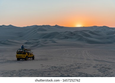 Huacachina, Peru August 31 2019 : Man Enjoying The View Of Sunset On Dune Buggy Peru South America