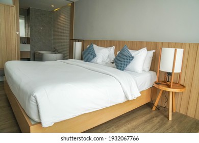 Huahin Thailand - February 2021: minimal double bed white mattress with Jacuzzi tub in luxury hotel bedroom