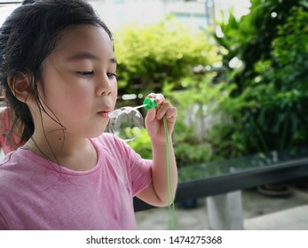 Huai Khwang Bangkok - August 2019: White girl, five years old, blowing bubbles in the holidays.in Thailand