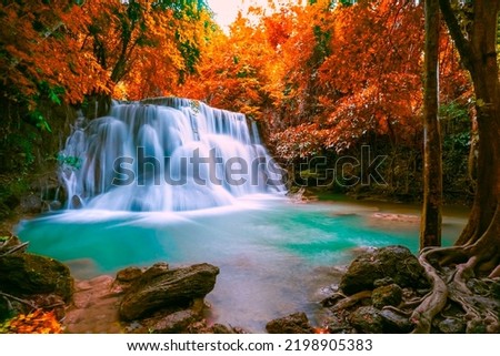 Huai Mae Khamin waterfall at Kanchanaburi Thailand, Hot Springs Onsen Natural Bath is Surrounded by red-yellow leaves. In fall leaves, Waterfall among many foliages, In fall leaves Leaf color change,