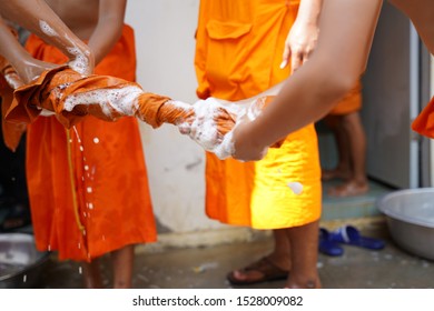 Huai Rat/Thailand – Apr 1-11, 2019: Novices wash their yellow rope themselves with their hands  on summer novice ordination  programme at Wat Phrasat Sung, Huai Rat, Buriram. - Shutterstock ID 1528009082