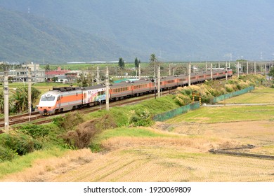 Hualien, Taiwan-1／17／2021: Taiwan Railway Limited Express train passes beside the field. - Shutterstock ID 1920069809