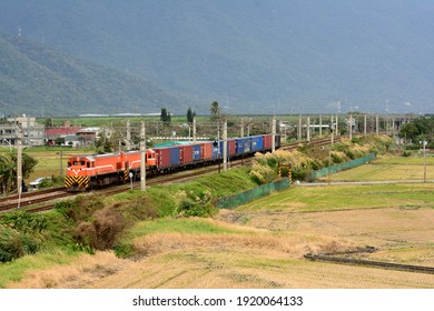 Hualien, Taiwan-1／17／2021: Two diesel-electric locomotives hauled container trains through the fields. - Shutterstock ID 1920064133