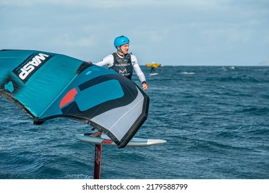 Huaraki Gulf, Auckland  New Zealand - 230221: Two men wing foil in the ocean between Great Barrier Island and Auckland, using hand held inflatable wings and hydrofoil surf boards.