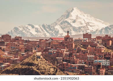 Huayna Potosí Mountain in the background of a brick houses in La Paz, Bolivia.