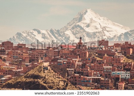Huayna Potosí Mountain in the background of a brick houses in La Paz, Bolivia.