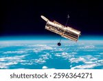 The Hubble Space Telescope hovers at the boundary of Earth and space.  