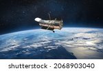 Hubble space telescope on orbit of Earth planet. Space observatory research. Elements of this image furnished by NASA