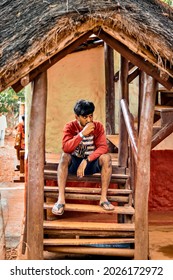 Hubli, Karnataka, India - July 31, 2021: A Young South Indian Man Drinking Tea In A Village House.