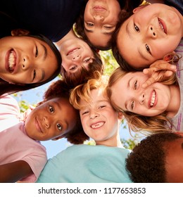 A Huddle Of School Kids Looking Down At Camera, Close Up