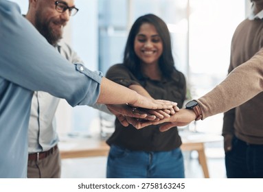 Huddle, stack of hands and teamwork with business people in office for motivation or support. Meeting, solidarity and unity with happy employee group at work together for collaboration or success