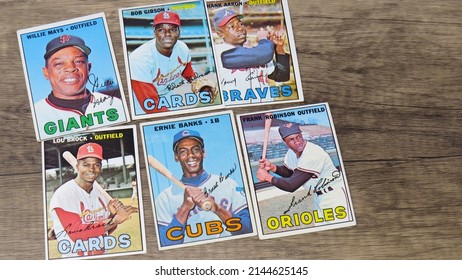 Hudson, Massachusetts USA - April 10, 2022: Vintage Cards Of Famous African American Baseball Players Of The 1960s Laid Out On Wooden Surface.