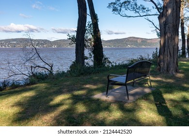 Hudson River Riverfront In Sleepy Hollow New York With An Empty Bench At Devries Park