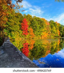 Hudson Valley NY Fall Season With Lake Reflection Of The Red, Orange And Yellow Leaves. 