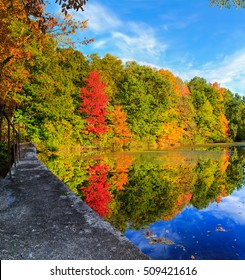 Hudson Valley NY Fall Season With Lake Reflection Of The Red, Orange And Yellow Leaves. 