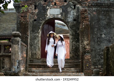 HUE, VIETNAM, MAY 3: Vietnamese girls with Ao Dai in Tu Duc royal tomb on May 3, 2014 in Hue, Vietnam. Ao dai is famous traditional costume for woman in VIetnam. 