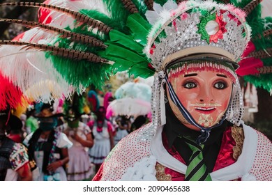 Huehues Mexico, mexican Carnival dancer wearing a traditional folk costume and mask in Latin America