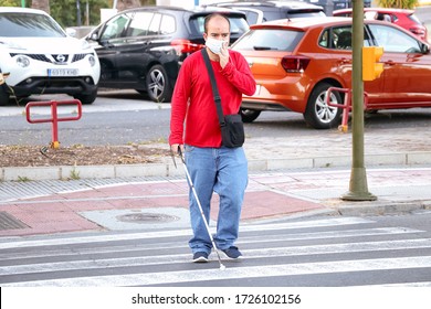 Huelva,Spain - May 8,2020: Blind Person With White Stick Walking On Street And Crossing A Crosswalk. He Is Wearing Protective Mask Due To The Alarm State And Quarantine In Spain